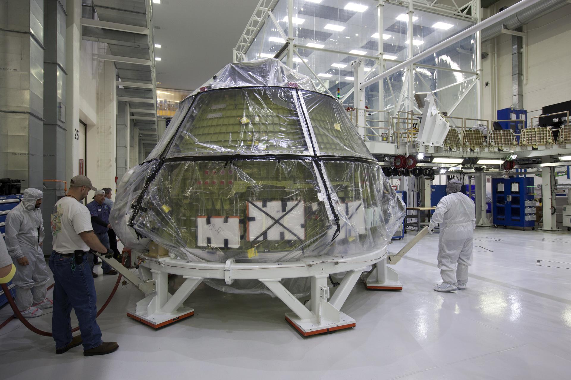 NASA Orion crew module moved through a clean room during spacecraft integration